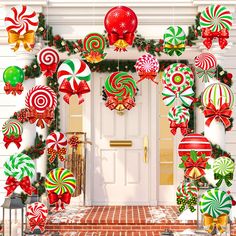 christmas decorations on the front door of a house with candy canes and candies