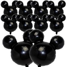 a bunch of black balloons sitting on top of each other