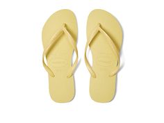 Havaianas Slim Flip Flops - Women's Sandals : Lemon Yellow : Please note: The molds for the Slim style have changed and no longer include the word Slim on the footbed. Make the 'Slim' sandal your go-to sandal for the Spring/Summer season. Rubber upper. Thong construction with embossed logo. Cushioned insole. Rubber sole. Measurements: Weight: 5 oz Product measurements were taken using size 37/38 Brazil (US Men's 5/6, Women's 7/8), width M. Please note that measurements may vary by size. Weight o Classic Summer Flip Flops, Classic Beach Flip Flops With Textured Footbed, Classic Beach Flip Flops For Summer, Classic Summer Beach Flip Flops, Classic Adjustable Flip Flops For Summer, Classic Adjustable Summer Flip Flops, Yellow Flip Flops, Slim Style, Pastel Yellow