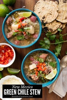 two bowls of green chile stew with tortillas and limes on the side