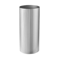 a tall metal vase sitting on top of a white floor