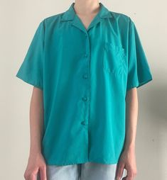 "brand: Port Camard 100% polyester with one front pocket (please check measurements because it fits more like a medium) shoulder to shoulder: 17.5\" pit to pit: 22\" length: 24.5\" sleeve length: 10\" (model is 5'4\" and 115 lbs with a 26\" waist)" Blue Short Sleeve Camp Shirt With Pockets, Blue Blouse With Camp Collar And Relaxed Fit, Blue Blouse With Relaxed Fit And Camp Collar, Blue Short Sleeve Blouse With Button Closure, Blue Short Sleeve Blouse With Pockets, Blue Collared Short Sleeve Shirt With Pockets, Casual Turquoise Short Sleeve Blouse, Blue Collared Camp Shirt With Pockets, Blue Short Sleeve Camp Shirt With Button Closure