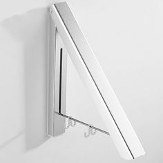 a white wall mounted shelf with two hooks on it's side and an umbrella hook attached to the bottom