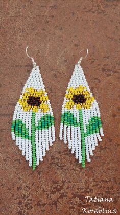 "These handmade unique earrings \"Sunflower\" are made of high-quality Czech beads and strong synthetic thread. I use my author's scheme . They are elegant, fashionable, and highly versatile, suitable for everyday wear. Color: white,yellow,brown,green . Copy without my permission is prohibited For those who want to buy my copyright scheme for these earrings: https://www.etsy.com/uk/listing/1056785837/brick-stitch-pattern-for-seed-bead?ref=shop_home_active_2 100% hand made with love! Measurements Sunflower Beaded Earrings, Chandelier Boho, Native Earrings, Beaded Earrings Native, Earrings Chandelier, Brick Stitch Pattern, Gifts For An Artist, Seed Bead Earrings, White Earrings