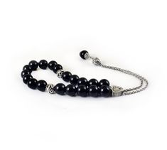 Handcrafted Greek Komboloi - Worry Beads created from silver tone metal chain of 20 black onyx Beads, 2 metal round beads and triangle shape metal Master Bead. A pocket sized set of greek worry beads which can be used for passing time and relaxation. It would also make a beautiful gift. Features: Item Length: 23cm / 9 inches Beads Size: 10mm / 0.40 inches Beads Material: Black onyx beads Metal Materials: Silver tone alloy Here you can browse more items in our shop: https://www.etsy.com/shop/sunn Greek Worry Beads, Chistmas Gift, Worry Beads, Onyx Bead, Beaded Material, Triangle Shape, Necklace Sizes, Metal Beads, Metal Chain