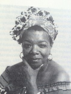 an old black and white photo of a woman wearing a head scarf with flowers on it