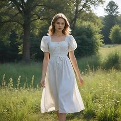 This sweet white dress is really classic and elegant with its square neck and puffed-up sleeves. It features a fitted, buttoned bodice with a small tie at the natural waistline, which will let a woman emphasize her curves while still being comfortable. Its length is just below the knee for a chic outfit on everyday casual as well as special occasions. This dress is thoughtfully designed in every single detail and created with love so that every time you wear it, you shall look beautiful and feel Knee Length Dress Outfit Casual, Cottage White Dress, Elegant Prairie Dress With Fitted Bodice And Square Neck, White Square Neck Dress With Buttons, Elegant Fitted Prairie Dress With Square Neck, White Vintage Dress With Square Neck And Fitted Style, Elegant White Vintage Dress With Square Neck, White Puff Sleeve Prairie Dress, White Square Neck Cottagecore Midi Dress