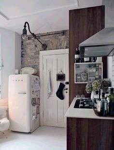 a white refrigerator freezer sitting inside of a kitchen