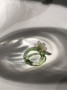 One-of-a-kind unique handmade borosilicate glass daisy flower ring in a beautiful translucent green and semi opaque white and yellow glass.  Hi, nice to digitally meet you :) My name is Maureen I am a 20-something jewellery artist with a specialisation in glass jewellery located in the Netherlands. The ring you are currently looking at is formed using a technique called lampworking. It is made from borosilicate glass also called medical-grade glass as it is the sturdiest kind of glass.  Jewel is Green Flower Ring Gift, Unique White Flower Ring, Green Glass Flower-shaped Jewelry, White Flower Shaped Glass Jewelry, Green Flower-shaped Glass Jewelry, Handmade Green Flower Ring, Vintage Green Flower Ring, Green Flower-shaped Ring For Gift, Green Flower Shaped Ring For Gift