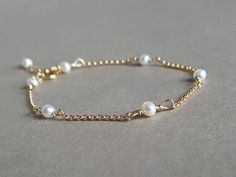 A dainty, elegant pearl and gold bracelet!  Please measure tightly your wrist's circumference, using a ribbon or something similar, and then measuring the ribbon with a ruler. When ordering, please select the actual wrist size, not the size of the bracelet. I will make the bracelet fit your wrist, by adding approx 0.6 inch to the circumference. The bracelet was set up using cultured pearls and gold filled findings it is adjustable. Available also in sterling silver or rose gold filled finish.  Pearls are a symbol of purity, faith, charity, innocence, integrity, focus, wisdom, spirituality, sincerity. Healing lore: Fertility, childbirth, digestion, muscular system. DISCLAIMER: Healing Gemstones are not a replacement for professional medical care. Materials: ~ culture pearls ~ gold filled/st Adjustable 14k Gold-filled Elegant Pearl Bracelet, Elegant 14k Gold Filled Pearl Bracelet, Dainty Adjustable Pearl Bracelet For Formal Occasions, Adjustable 14k Gold-filled Pearl Bracelet For Wedding, Elegant 14k Gold-filled Pearl Bracelet Gift, Delicate Gold Pearl Bracelet For Anniversary, Minimalist Yellow Gold Pearl Bracelet For Wedding, Elegant 14k Gold Filled Pearl Bracelet For Wedding, Dainty 14k Gold Filled Pearl Bracelet For Wedding