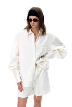 Classic White with a Modern Twist Elevate your wardrobe with this oversized white shirt, a perfect blend of classic and contemporary elements. The shirt features a loose fit with dropped shoulders, creating a relaxed yet refined silhouette that¡¯s ideal for both casual and formal wear. The high-quality fabric offers a soft and comfortable feel, making it an excellent layering piece or a standalone statement. Designed with modern sensibilities, this shirt is versatile enough to complement various White Tops With Button Cuffs And Relaxed Fit, Modern White Blouse With Cuffed Sleeves, Classic White Oversized Shirt, White Effortless Shirt With Shirttail Hem, Classic Oversized White Shirt, Modern Oversized White Blouse, Effortless White Shirt For Everyday, Chic Oversized White Shirt, White Blouse With Cuffed Sleeves For Daywear