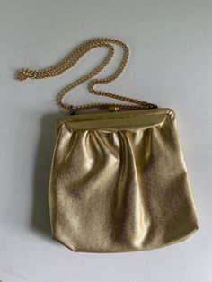 "This 1950s metallic gold vintage purse has a metal adjustable 28\" strap that can be used as a shoulder bag or doubled up and carried as tote.  It measures 8.5\" x 8.5\" and has a depth of 2\" open. Impeccable peach satin interior. Perfect vintage condition." Vintage Gold Shoulder Bag For Party, Vintage Gold Shoulder Bag With Gold-tone Hardware, Gold Crossbody Shoulder Bag For Party, Vintage Formal Bags With Gold Clasp, Retro Evening Crossbody Shoulder Bag, Vintage Clutch Shoulder Bag For Party, Retro Gold Rectangular Shoulder Bag, Vintage Gold Shoulder Bag For Formal Occasions, Gold Satchel Bag For Party