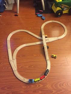 a toy train set is laying on the floor next to a child's table