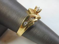 FOR SALE IS THIS VINTAGE ESTATE 14K GOLD DIAMOND RING. THE RING IS A SIZE 7.5 AND WEIGHS 5.5g. THERE ARE ABOUT .42cts WORTH OF DIAMONDS. THE RING MAKES A BEAUTIFUL GIFT FOR THAT SOMEONE SPECIAL. ANY OTHER QUESTIONS, PLEASE ASK. BE SURE TO CHECK OUT SOME OF MY OTHER GREAT ITEMS UP FOR SALE. THANK YOU IF THERE ARE ANY ISSUES PLEASE CONTACT US, WE'RE ALWAYS HAPPY TO TRY TO HELP YOU OUT AS BEST AS WE CAN. Collectible Gold Diamond Ring With Brilliant Cut, Classic Gold Diamond Ring Collectible, Classic Gold Diamond Ring For Collectors, Antique Gold Diamond Ring With Vvs Clarity, Vintage Gold Diamond Ring With Vvs Clarity, Vintage Gold Diamond Ring For Formal Occasions, Vintage Gold Diamond Ring For Collectors, Vintage Gold Cluster Ring With Round Cut, Vintage Gold Cluster Ring For Anniversary