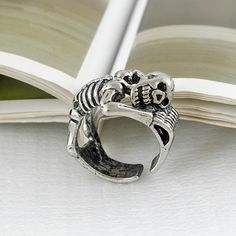 If you're searching for a unique and bold ring that stands out from the crowd, look no further than this adjustable unisex skeleton ring. Perfect for bikers, baristas, or bartenders, this eye-catching piece will ensure you always make a lasting impression. Embrace your individuality and showcase your edgy style with this unforgettable accessory. Why You'll Love It An eye-catching design: Get rid of the boring rings and get your hands on this uniquely impressive skeleton ring. Stand out in a crow Adjustable Punk Metal Rings, Adjustable Metal Punk Rings, Adjustable Punk Style Metal Rings, Adjustable Punk Rings For Halloween, Adjustable Silver Skull Ring Punk Style, Adjustable Silver Skull Ring In Punk Style, Adjustable Metal Skull Ring Punk Style, Adjustable Metal Skull Ring In Punk Style, Adjustable Metal Punk Skull Ring