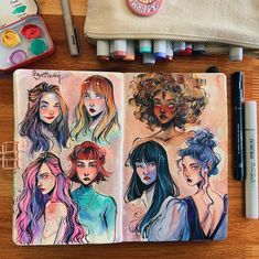 an open notebook with four different colored girls on it and some markers next to it