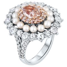 Presenting an exquisite Victorian-style Cocktail ring showcasing a mesmerizing 1.42 Carat Fancy Pink Brown Diamond in an oval shape, GIA Certified with VS1 clarity and Even color distribution. This stunning masterpiece embodies unrivaled beauty and sophistication. The central diamond is elegantly encircled by round brilliant pink diamonds and pearls, adding a touch of refinement. Additionally, it is adorned with 34 round brilliant white Diamonds totaling approximately 1.48 carats, complemented by 32 round brilliant diamonds totaling approximately 0.41 carats. Crafted with precision in a polished 18k Pink gold & 18k white gold mounting, this ring symbolizes true luxury. The total diamond weight is 3.31 carats, making this cocktail ring a statement piece of timeless charm and opulence. This Ring With Pearls, Diamonds And Pearls, Pink Diamonds, Diamond Cocktail Ring, Diamond Cocktail Rings, Brown Diamond, Fancy Color Diamonds, Pink Diamond, Pearl Ring