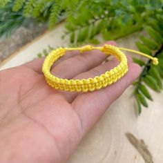 "Happy color macrame bracelet made of waxed cord. This waterproof adjustable bracelet has the perfect color to transmit energy, vibrant yellow! The color of the sun. This happy bracelet was designed for everyday wear. This minimalist boho yellow cord bracelet enhances your casual outfit.  ♥ ITEM DETAILS: Total length: The size of the bracelet is adjustable.  💕The bracelet has an adjustable closure that will work on a wrist of about 6 - 7\"💕 Materials: Waxed cord Waxed Cord Available: Yellow Waxed Cord Size: 1mm waxed cord ♥ GIFT IT Jewelry comes in a cute canvas bag ready to gift! If you wish your item to be a gift, please let me know and I will include a cute little card with a personal message. ♥ CURRENT PROCESSING TIMES: normally we ship orders out within 1-3 days  (the time I need to Handmade Trendy Yellow Friendship Bracelets, Yellow Bohemian Friendship Bracelets For Everyday, Yellow Bohemian Friendship Bracelets, Bohemian Yellow Friendship Bracelets, Handmade Yellow Friendship Bracelets, Yellow Braided Friendship Bracelets, Adjustable Yellow Bracelets For Friendship, Yellow Adjustable Cord Bracelet, Trendy Adjustable Yellow Friendship Bracelets