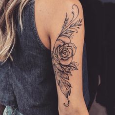 a woman with a rose tattoo on her arm