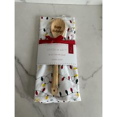 a wooden spoon in a gift bag on a marble surface