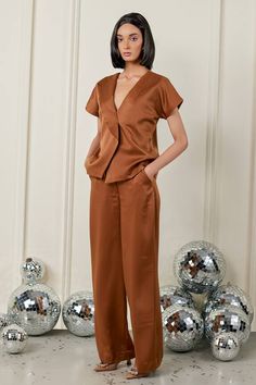 Brown half sleeve shirt in satin base. Paired with straight pant. - Aza Fashions V-neck Pant Set For Workwear, Silk Summer Workwear Sets, Chic Short Sleeve Workwear Sets, Elegant Silk Short Sleeve Sets, Elegant Short Sleeve Satin Set, Silk Sets With Straight Pants For Workwear, Spring Silk Workwear Set, Brown Plain, Half Sleeve Shirt