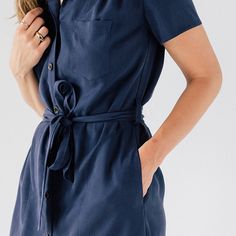 Without a doubt, the classic shirt dress is one of the most versatile garments a woman can own. This dress fits in at the most casual of establishments, but can transition easily to a fancier night out. Not too tight, not too loose, and made of a wonderfully soft and supple tencel fabric, our Shirt Dress is the first and last place our most discerning clientele looks. This item will be discontinued. Future orders will require a 50 piece MOQ. Features: Button Up Front, 20L Custom Engraved Corozo Classic Summer Dress With Spread Collar, Chic Fitted Shirt Dress With Placket, Elegant Button-up Shirt Dress With Rolled Sleeves, Elegant Dresses With Rolled Sleeves, Elegant Summer Shirt Dress With Rolled Sleeves, Fitted Collared Shirt Dress With Rolled Sleeves, Elegant Knee-length Dresses With Rolled Sleeves, Workwear Dresses With Relaxed Fit And Spread Collar, Chic Button-up Shirt Dress With Rolled Sleeves