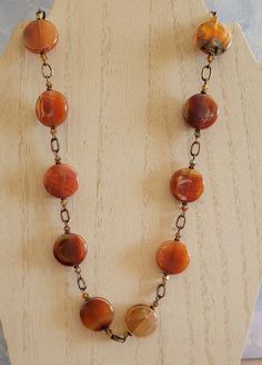 I fell in love the with rainbow hues in these coin shaped Carnelian beads.  In the sun, the colors just glow!  I've paired them with copper chain links and a copper toggle clasp.  I've also paired these beads with matching 2x ab Carnelian bicone crystals.  This necklace measures approximately 20 inches. Handmade Orange Beads For Jewelry Making, Adjustable Round Carnelian Jewelry, Orange Agate Oval Beads Jewelry, Orange Agate Oval Beaded Jewelry, Polished Round Carnelian Beads Jewelry, Amber Beads And Cabochons For Gift, Orange Gemstone Beads Round Jewelry, Orange Round Gemstone Bead Jewelry, Handmade Round Agate Beads, Gems, And Cabochons