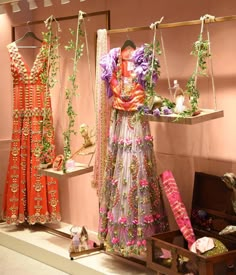 an assortment of dresses and accessories on display