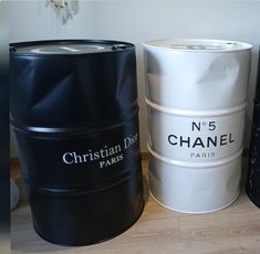 three black and white barrels sitting next to each other