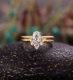 a diamond ring sitting on top of a rock