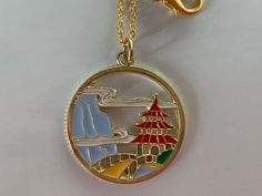 Pagoda Gold Enamel Necklace Beautiful view of a red roof pagoda with entrance from a golden yellow bridge accented by a blue mountain and lucky clouds in the background. It is single sided with a flat textured gold tone back. 18 inch Gold Plated Brass Cable Chain Soldered links 2mmx1.5mm attached to Gold Enamel Pagoda Charm 27mmx27mm All charm materials Zinc Alloy Metal and Enamel Tone Back, Red Roof, Enamel Necklaces, Beautiful View, Enamel Earrings, Cute Necklace, Blue Mountain, Gold Enamel, Display Cards