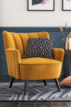 a yellow chair sitting on top of a rug