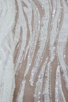 "Heavy 3D Beaded Lace Fabric, Embroidery Lace Fabric With Sequins for Wedding Bridal Dress, Haute Couture Beaded Lace Fabric By The Yard The Lace Fabric is for 1 yard,You will receive the fabric in one continuous piece if you purchase more than 1 yard. ❤ ITEM INFORMATION Width about: 51inch (130Centimeters) Length : 91 Centimeters/ 1Yard Material: Beaded, Sequins, Rayon Yarn, Nylon Mesh Colors: Off-White,Transparent Sequins, Off-White Beaded NO: M8045 ❤ NOTE We offer special discounts for design White Sequin Fabric For Wedding, White Beaded Wedding Dress For Party, Fitted White Embellished Embroidered Fabric, White Beaded Sequin Fabric For Wedding, Fitted White Sequin Fabric With Rhinestones, White Beaded Embroidered Fabric For Wedding, White Fitted Sequin Fabric With Rhinestones, Luxury White Sequin Fabric With 3d Embroidery, Elegant White Sequin Fabric With Intricate Embroidery