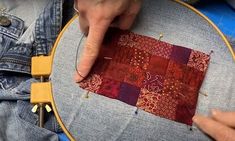 someone is stitching something on a piece of fabric