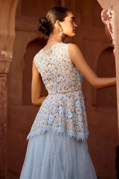 Powder blue peplum blouse with embroidered floral blossom motifs highlighted by sequins and beads. Comes with solid tiered hem lehenga and ruffle dupatta. - Aza Fashions V-neck Wedding Tops With Intricate Embroidery, Blue Floral Embroidered Tops For Wedding, Blue Floral Embroidery Tops For Wedding, Blue Fitted Embroidered Top For Wedding, Elegant Sleeveless Blue Lehenga, Elegant Blue Top With Intricate Embroidery, Elegant Blue Tops With Intricate Embroidery, Festive Sleeveless Lace Dress, Fitted V-neck Embroidered Top For Wedding