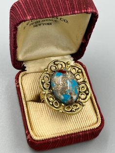 Stunning adjustable costume estate ring, best for sizes 6-9. Fabulous chunky stone with turquoise background and mixed flecks of red, gray, and cream. Excellent condition! Vintage Gold Turquoise Ring, Vintage Multicolor Turquoise Ring, Multicolor Vintage Turquoise Ring, Vintage Turquoise Ring With Large Stone For Gift, Vintage Multicolor Rings For Jewelry Making, Estate Ring, Vintage Cocktail Ring, Estate Rings, Turquoise Background