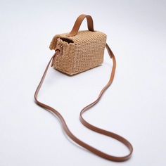 Description:This raffia mini bag is the must-have accessory of the season! Crafted with raffia-like fabric and imitated leather. stand out in handmade weave details allover. featuring a leather top handle. a flap top accented with a metallic lock closure. a massive compartment. and an adjustable shoulder strap decorated with seamed stitching charms. Find more trendy women's woven bags or unique bags in our boutique. and style it with a floral sundress for an idyllic look. Size One Size(in) One S Rattan Handbags, Woven Bags, Summer Handbags, Leather Stand, Floral Sundress, Trim Top, Unique Bags, Market Bag, Woven Bag