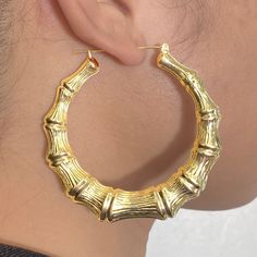 There is nothing more stylish than a pair of 10-karat Yellow Gold Bamboo Hoop Earrings. They're a versatile look that can be paired with any kind of outfit and are suitable for any occasion. The click-snap earring closures support a full hoop shape that is crafted in resilient, eye-catching 10k Yellow Gold. Its gold composition is tougher than most gold types, allowing it to withstand years of daily wear. These hoops measure 2.90 inches from side to side. Bamboo Hoop Earrings are a wonderful gif Trendy Yellow Gold Hoop Earrings, Clean Gold Jewelry, Bamboo Hoop Earrings, Bamboo Earrings, Nothing More, 10k Gold, Real Gold, Gold Chains, Pink And Gold