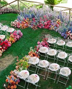 an arrangement of tables and chairs with flowers on them