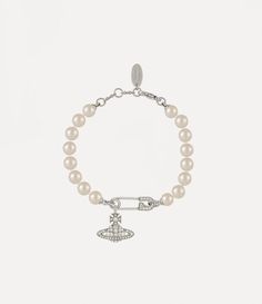 Pearls remain an essential element of the house’s iconography, evoking both a sense of luxury and rebellion. The Lucrece Pearl bracelet features a row of glass-based pearls, complete with a crystal-encrusted orb, dangling from a safety pin charm. Our timeless safety pin details feature as a symbol of non-conformity, reminiscent of Vivienne’s signature punk approach. Luxury Streetwear Jewelry, Vivienne Westwood Charm Bracelet, Vivienne Westwood Bracelet, Channel Outfits, Streetwear Jewelry, Punk Inspiration, Detailed Jewelry, S Signature, Jewelry Inspo