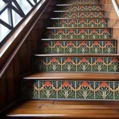 an artisticly designed stair case with flowers painted on the steps and handrails