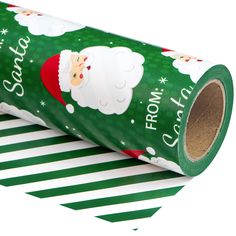 a roll of green christmas wrapping paper with santa claus on it's face and snowflakes