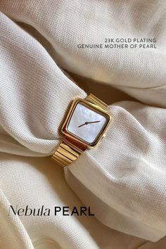 The Nebula Pearl embodies a classic aesthetic and modernism. Easily elevate your date-night look or transform your loungewear to casual chic. The genuine white Mother of Pearl dial pairs beautifully with the 23-karatt gold mesh bracelet, the perfect gift for yourself or a loved one. Mother Of Pearl Watch, Elegant White Jewelry With Rectangular Dial, Minimalist White Everyday Watch, White Minimalist Everyday Watch, Classic White Rectangular Bracelets, Elegant White Watches With Metal Dial, Gold Watches With Rectangular Dial For Everyday Luxury, Elegant Everyday Watch With Polished Finish, White Watches With Diamond Hour Markers And Rectangular Dial