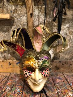 Original hand-painted Venetian mask embellished with gold leaf, stucco decoration, acrylic colors and precious fabrics. -Material/Resin Made in Italy hypoallergenic and anatoxic -Size/50x40Unisex -History of the mask/the Jester or joker is a mask that appears in Venice in 1970, the year in which the Venetian Carnival returns to its former glory after being interrupted during the Napoleonic (1700') and Austro-Hungarian (1800') dominations. Formerly a symbol of transgression and pleasure-loving li Jester Mask Masquerade Ball, Venetian Jester Mask, Traditional Baroque Masquerade Mask For Carnival, Jester Masquerade Mask, Candyland Characters, Venetian Jester, Baroque Masks For Theater And Carnival, Venetian Baroque Mask For Carnival, French Dresses