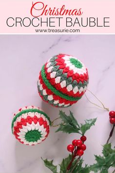 christmas crochet bauble with holly and berries on the table next to it