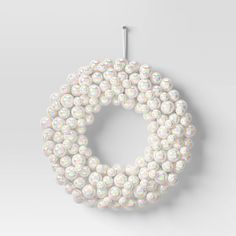 a white beaded wreath hanging on a wall