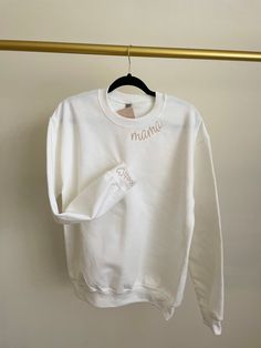 This super soft, comfy Sweatshirt is perfect for mama! It is the perfect mom fit for any day.  The word "mama" is embroidered in lilac color thread on a beige sweatshirt.   Personalized it by choosing thread color for "mama", sweatshirt  color and you can add your kid's initial to add a personal touch!  Are you looking for an item that is not listed? Please send me a message, I'd be happy to help create something special for you! Returns: All items are made-to-order. Because of the nature of these items, unless they arrive damage or defective I can't accept returns. I gladly accept cancellations within 4 hours of purchased you have only 4 hours to make any  changes or cancelations. refer back to our policy if you have any questions reach out, happy to answer all your questions or concerns. Custom Embroidered White Tops For Mother's Day, Personalized White Sweatshirt For Gift, White Everyday Sweatshirt With Letter Embroidery, White Tops With Letter Embroidery For Mother's Day, White Sweatshirt With Letter Embroidery For Everyday, White Sweatshirt With Letter Embroidery, Personalized White Cotton Top, Mother's Day Gift Sweatshirt, White Sweatshirt With Letter Embroidery As Gift