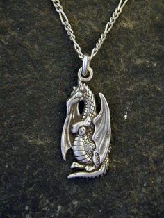 This Dragon  pendant is Sterling Silver. The included chain is a Sterling Silver Figaro 50 chain. You may choose 16, 18 or 20 inch at the same price. Other length available at sightly higher prices. This Dragon pendant measures 1" tall by 1/2" across.  I hand cast all my pieces using the lost wax casting method. Please ask your needs. You may call me with questions, often I am out so please use my machine. 831-476-3176. Satisfaction Guaranteed!I send items USPS First Class unless otherwise direc Symbolic Metal Chain Necklace, Metal Charm Necklace With 16 Inch Length, Metal Charm Necklace With 16 Inch Pendant, 16 Inch Metal Pendant Charm Necklace, Silver Necklace With 16 Inch Round Pendant, Metal Necklace With Round Pendant And Box Chain, Metal Box Chain Necklace With Round Pendant, Metal Necklace With Box Chain And Round Pendant, Symbolic Silver Necklace With Adjustable Chain