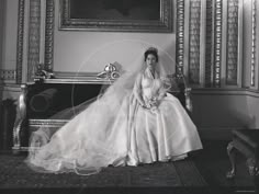 an old black and white photo of a woman in a wedding dress