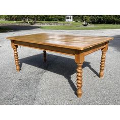 a wooden table sitting in the middle of a parking lot